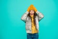 Surprised kid in silver puffer jacket and knitwear get warm in winter ready for activity on holidays, copy space