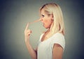 Surprised liar woman with long nose. Lies concept. Human emotions, feelings. Royalty Free Stock Photo