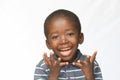 Surprised little African boy excited about getting a present isolated on white