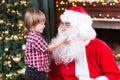 Surprised Little Boy Looks At Fake Santa Claus
