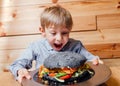 Surprised little boy with vegetarian black burger Royalty Free Stock Photo