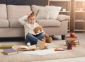 Surprised little female child hugging her teddy bear and reading Royalty Free Stock Photo