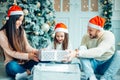 Surprised Little girl with Christmas gifts near a Christmas tree at home Royalty Free Stock Photo