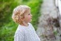 Surprised little girl in white sweater. Children& x27;s emotions. A child on the background of the grass in autumn Royalty Free Stock Photo