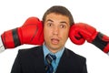 Surprised man between boxing gloves