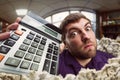 Surprised man with calculator Royalty Free Stock Photo