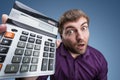 Surprised man with calculator Royalty Free Stock Photo