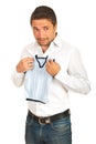 Surprised man holding shrunk vest