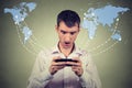 Surprised man holding smartphone connected browsing internet Royalty Free Stock Photo