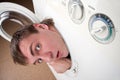 Surprised man inside washing machine Royalty Free Stock Photo