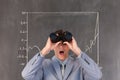 Surprised man looking through binoculars against background with infographics Royalty Free Stock Photo