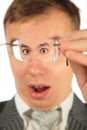 Surprised man peers into spectacles Royalty Free Stock Photo