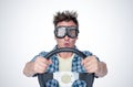 Surprised man in plaid shirt and stylish goggles with steering wheel, front view. Car driver concept