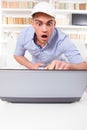 Surprised man pointing at computer monitor with shock Royalty Free Stock Photo