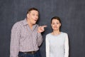 Surprised man is pointing at funny stupid woman Royalty Free Stock Photo