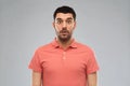 Surprised man in polo t-shirt over gray background Royalty Free Stock Photo