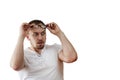 Surprised man, shocked with bulging eyes, glasses climbed over his forehead, isolated on white background Royalty Free Stock Photo