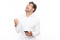 Surprised man with short dark hair holding cell phone and clench Royalty Free Stock Photo