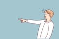 Surprised man with WOW emotions points finger to side to draw customer attention to copy space Royalty Free Stock Photo