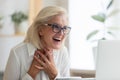 Surprised middle-aged female employee read good email on laptop