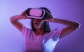 Surprised millennial girl in virtual reality glasses