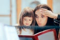 Surprised Mom and Happy Daughter Reading a Book Together Royalty Free Stock Photo