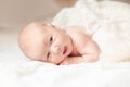 Surprised newborn babe lying on the bed. Royalty Free Stock Photo