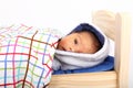 Surprised newborn baby boy in small wooden bed Royalty Free Stock Photo