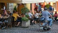 Crazy Motorcyclist drives through a pedestrian area filled with outdoor patio dinners in Rothenburg, Germany