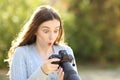 Surprised photographer checking mirrorless camera photos