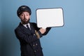 Surprised pilot holding white speech bubble with copy space Royalty Free Stock Photo