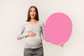 Surprised Pregnant Woman Holding Pink Speech Bubble, Over White Background