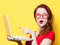 Surprised redhead girl with laptop and ID security points Royalty Free Stock Photo