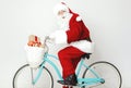 Surprised Santa Claus riding a bike with presents Royalty Free Stock Photo