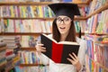 Surprised School Student Reading a Book in a Library Royalty Free Stock Photo