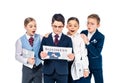 Surprised schoolchildren pretending to be businesspeople reading newspaper Isolated On White. Royalty Free Stock Photo