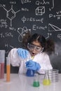 Surprised scientist girl mixing chemical flasks