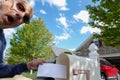 Surprised senior citizen bald male takes an envelope out of his mailbox