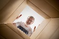 Man unpacking and opening carton box and looking inside Royalty Free Stock Photo