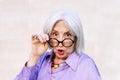 surprised senior woman looking over her glasses Royalty Free Stock Photo