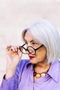 surprised senior woman looking over her glasses Royalty Free Stock Photo