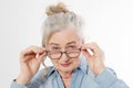 Surprised and shock Senior woman with wrinkle face and eye care glasses isolated on white background. Mature healthy lady. Copy Royalty Free Stock Photo