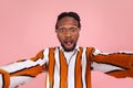 Surprised shocked african man blogger with beard and dreadlocks in striped shirt looking at selfie camera with astonishment, Royalty Free Stock Photo