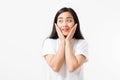 Surprised shocked excited asian woman face isolated on white background. Young asian girl in summer t shirt. Copy space.