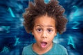 Surprised Shocked preschool boy in front of the blue technology background with flying letters and numbers around him