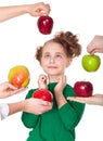 Surprised smiling girl choosing proposed apples