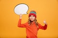 Surprised smiling Young girl in hat holding blank speech bubble Royalty Free Stock Photo