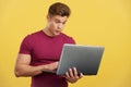 Surprised strong man standing using a laptop Royalty Free Stock Photo