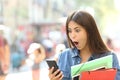 Surprised student girl watching phone content