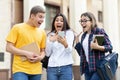 Surprised students checking exam results on smartphone Royalty Free Stock Photo